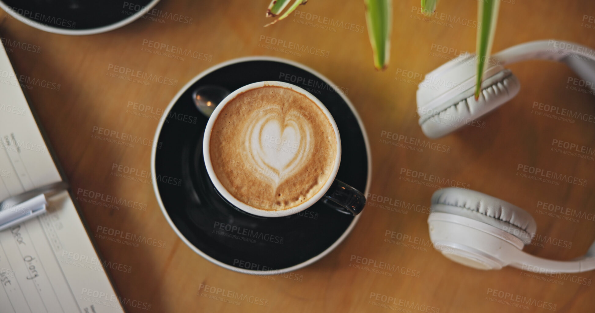 Buy stock photo Coffee, latte or drink with headphone from above in cafe, restaurant or bistro for breakfast. Hot beverage, delicious and sweet on table with technology for audio, music and listening with notebook