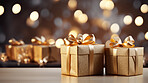 Christmas gift box, gold wrapping, golden bow, bokeh background.