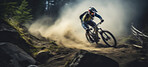 Fit mountain biker speeding downhill on a bike track in the forest or woods. Extreme sport