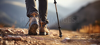 Closeup of hiking boots. trekking up a rocky mountain trail. Exploration and fitness