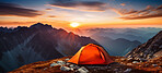 Orange camping tent on a mountain. Tourist camp and sunset or sunrise background