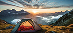 Orange camping tent on a mountain. Tourist camp and sunset or sunrise background