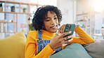 Phone, social media and relax with a woman on a sofa in the living room of her apartment for communication. Mobile, contact and app with a young person typing or reading a text message in her home