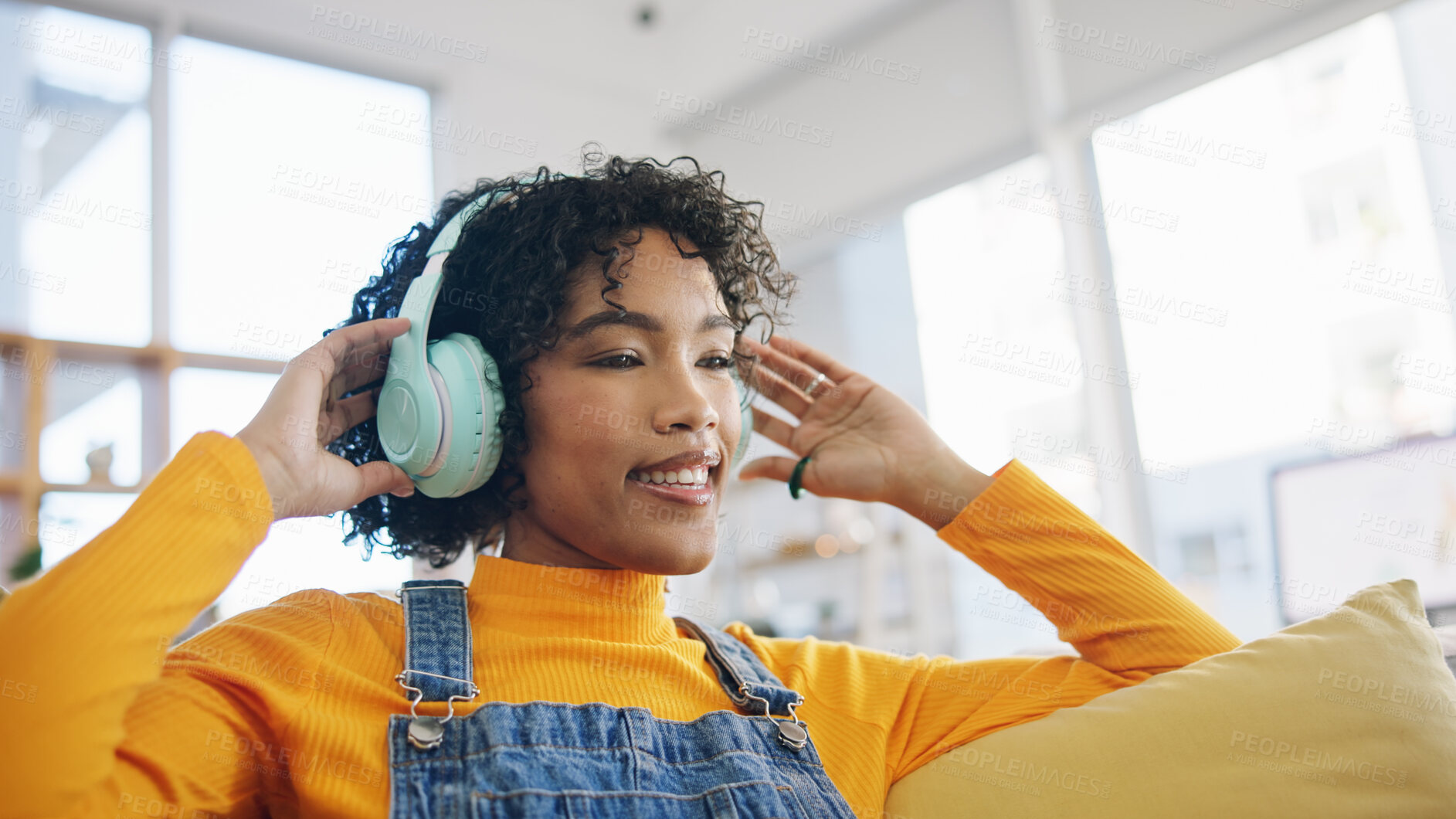 Buy stock photo Music, happy and dance with woman on sofa for streaming, relax and energy. Freedom, media and online radio with person listening to headphones in living room at home for technology, sound and audio