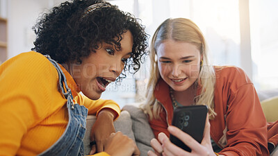 Friends, phone and talking on a home sofa with internet connection, social media and online chat. Women laughing together on a couch with a smartphone for communication, surprise or wow gossip