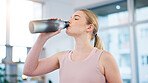 Woman, home and drink of water for sports break, energy and workout performance. Thirsty athlete, bottle and nutrition of hydration, diet or healthy liquid for training, exercise or fitness in lounge