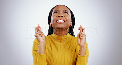 Buy stock photo Fingers crossed, praying and black woman in studio with sign of good luck for bonus, prize or lottery in white background. Hope, wish and nervous person with hands, emoji and waiting for results