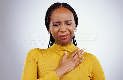 Buy stock photo Heart pain, black woman and ache with stress, anxiety and problem from cardiology crisis in studio. White background, African female person and heartburn with cardiac arrest and sick from grief