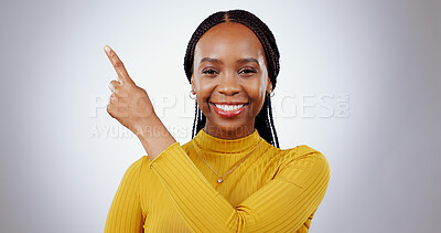 Buy stock photo Black woman, portrait and pointing in studio for advertising information, deal or choice on white background. Happy model, presentation or mockup space for feedback, promotion or announcement of news