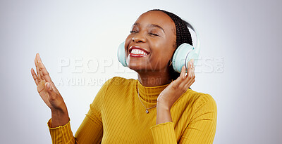 Buy stock photo Jazz, music or headphones with black woman, smile or peace in studio for streaming online radio. Relax, grey background or happy African girl listening to track, song or audio podcast on mobile app