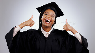 Buy stock photo Graduation, woman and student thumbs up for study success, celebration and education, learning or college in studio. Portrait of excited African graduate with yes and like emoji on a white background