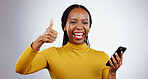 Phone, thumbs up and portrait of happy black woman in studio with review, feedback or vote on grey background. Success, emoji and face of lady model with thank you sign for smartphone, app or support