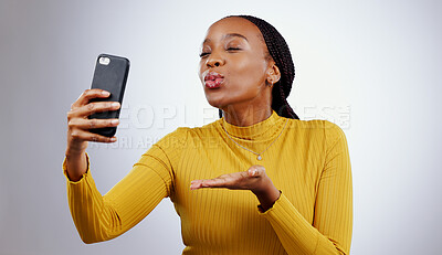 Buy stock photo Studio, kiss or black woman taking selfie on social media with confidence, post or smile online. African lady, memory or beauty influencer taking a photograph, vlog or picture on grey background