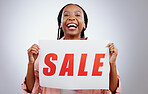 Portrait, sale sign or black woman by discount deal, offer or launch for poster or business advertising. Happy, studio or person with board for message, marketing or promotion card on grey background