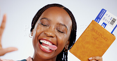 Buy stock photo Selfie, face or happy black woman with a passport in studio for holiday travel or post vacation trip online. Grey background, social media or African tourist with ticket or tongue out in celebration 