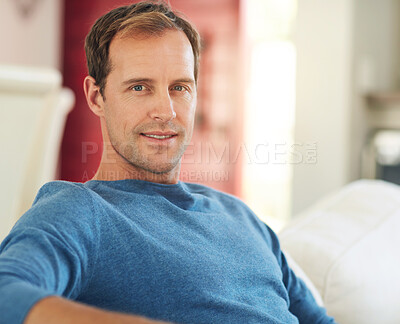 Buy stock photo Cropped portrait of a handsome man relaxing at home