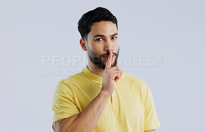 Buy stock photo Secret, man and portrait in studio for sign of privacy, surprise sales and confidential deal on white background. Indian model with finger on lips for quiet, gossip news and mystery emoji to whisper