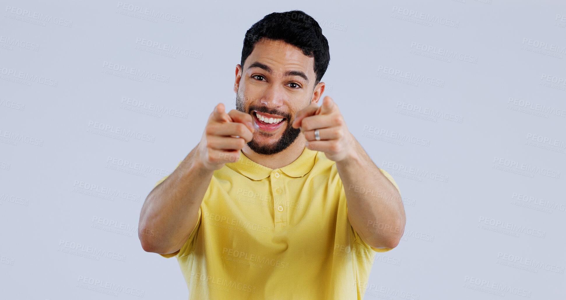 Buy stock photo Man, portrait and smile while pointing to you for decision, choice and vote for winner, volunteer or join us in studio on white background. Indian model show finger for support, emoji and recruitment