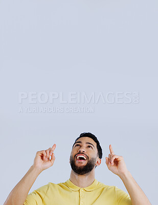 Buy stock photo Man, smile and pointing up to space in studio for advertising choice, decision or launch information on white background. Excited indian model, thinking and show presentation of mockup, ideas or news