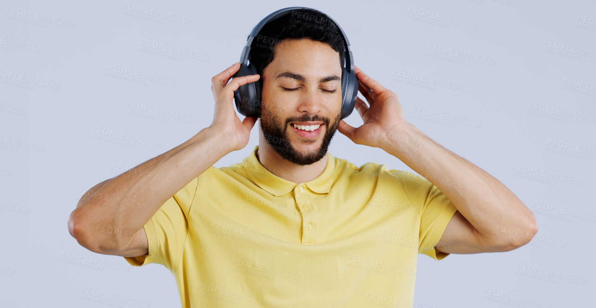 Buy stock photo Man, music and headphones in studio for freedom, audio subscription and streaming multimedia playlist on white background. Happy indian model listening to peaceful podcast, hearing sound and radio 