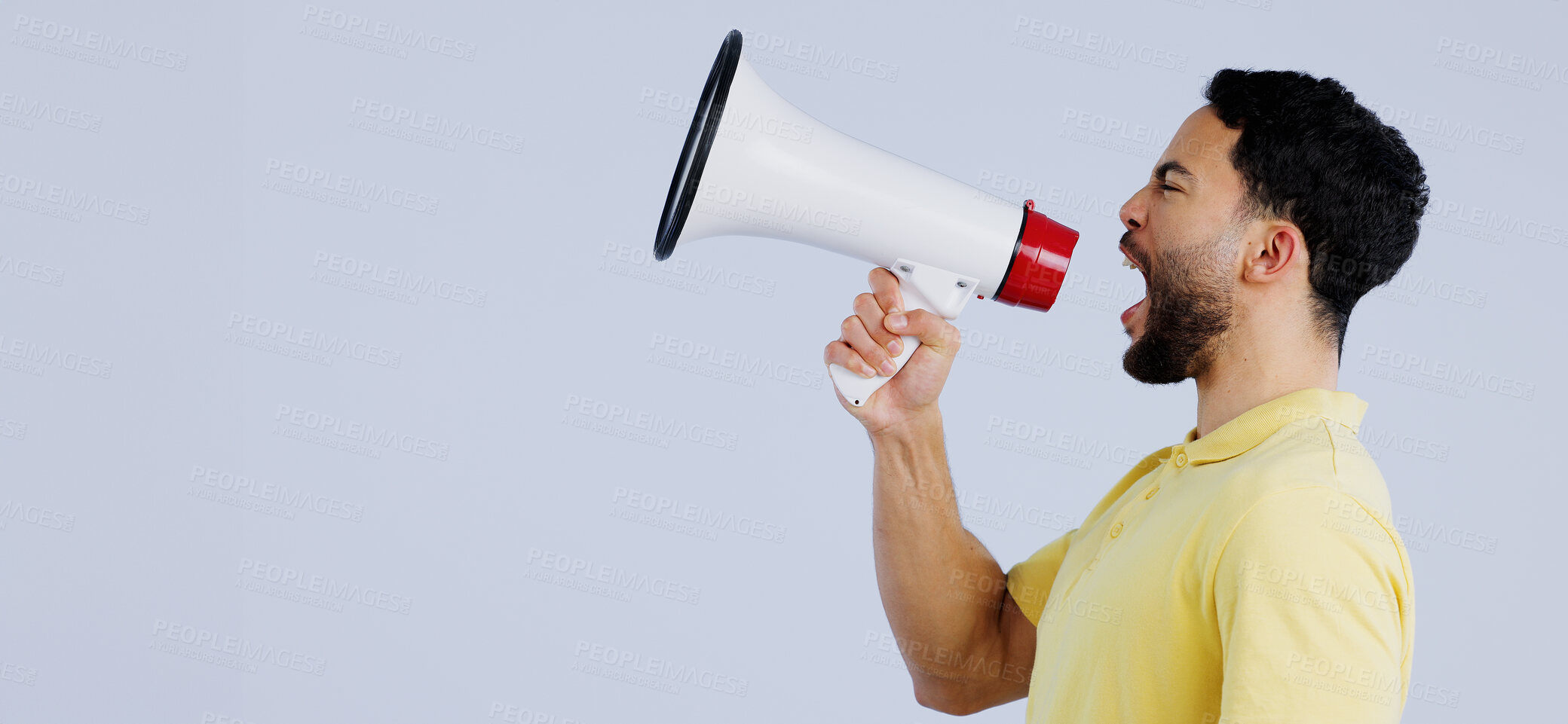 Buy stock photo Man, megaphone and studio profile in space, mockup and shout for rally, promo or announcement by background. Speaker, protest or call to action for justice with speech, sound and anger with bullhorn