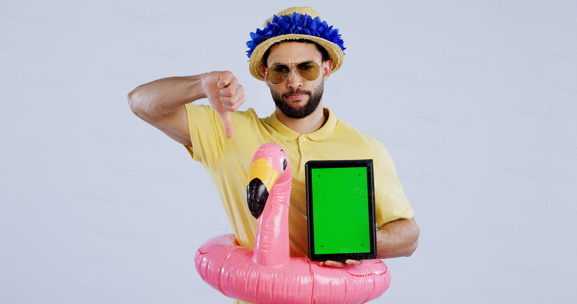 Buy stock photo Green screen, tablet and man with thumbs down in studio for travel agency, review or service feedback on grey background. Digital, space and sad male traveler with emoji vote for app disappointment