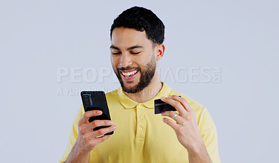 Buy stock photo Man, smartphone and happy with credit card for digital transaction, ecommerce and online shopping on white background. Young person, mobile and technology for iot, banking payment and studio mockup