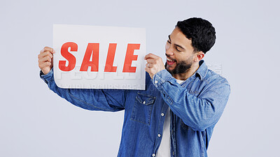 Buy stock photo Man, sale and excited with board in studio mockup, shopping discount and advertising retail announcement. Young person, arab and marketing for deal promotion with product launch by white background