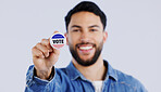 Vote, smile and portrait of man in studio with badge for choice, decision or registration on grey background. Government, politics and face of happy voter with support, freedom and party election 