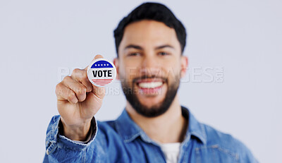 Buy stock photo Vote, smile and portrait of man with badge in studio for choice, decision or registration on grey background. Government, politics and face of happy voter with support, freedom and party election 