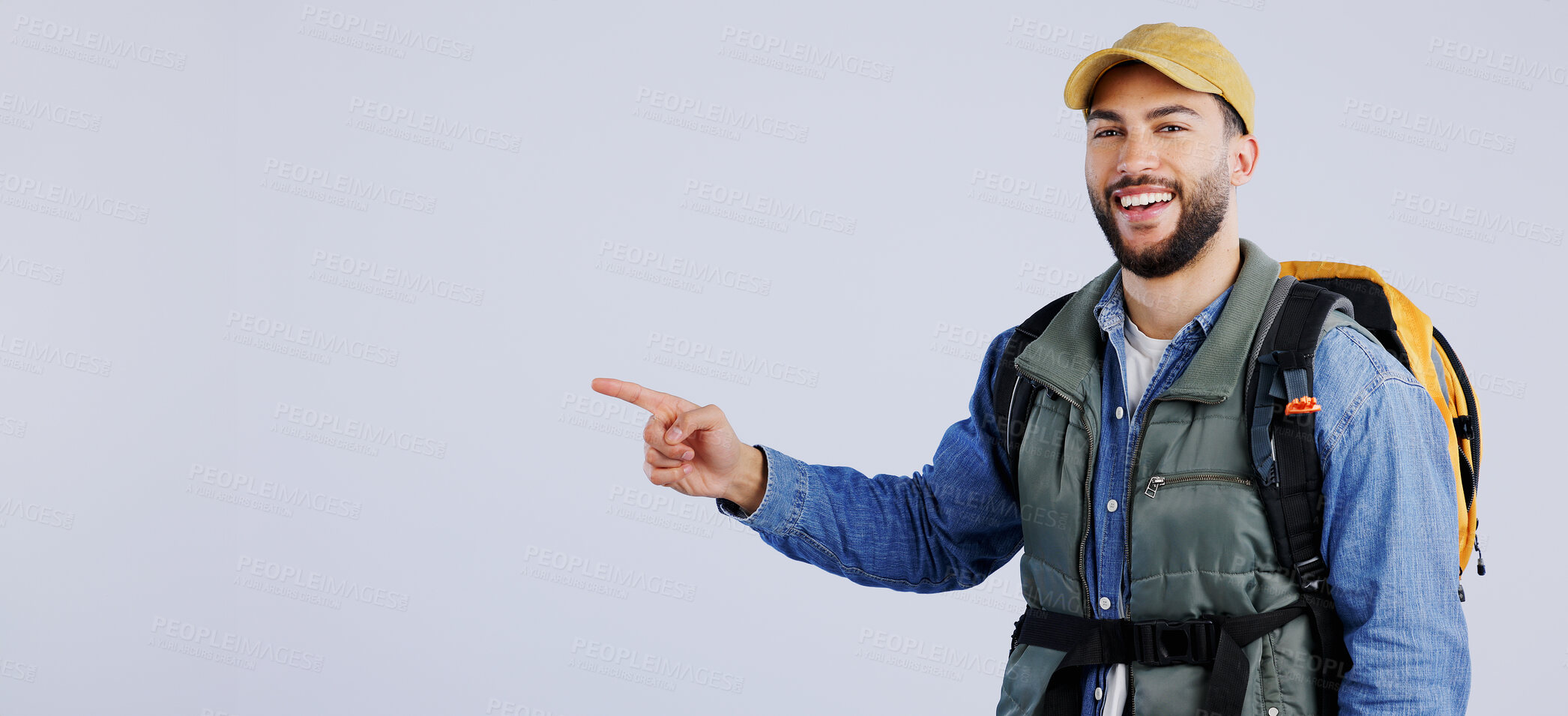 Buy stock photo Happy man, backpack and pointing on mockup for travel, adventure or hiking tips against a studio background. Banner of male person or hiker smile with bag showing trekking list, deal or advertising