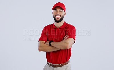 Buy stock photo Happy man, portrait and professional delivery guy with arms crossed in confidence against a gray studio background. Male person, model or courier worker smile with red hat for service on mockup space