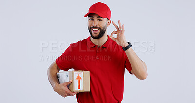 Buy stock photo Portrait, man and box with okay sign on studio for delivery, logistics and mockup for package on white background. Male model, worker or courier with gesture in Mexico for good, choice or decision