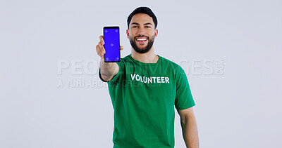 Buy stock photo Happy man, portrait and phone blue screen of volunteer for advertising app against a gray studio background. Male person smile showing mobile smartphone display for community service on mockup space