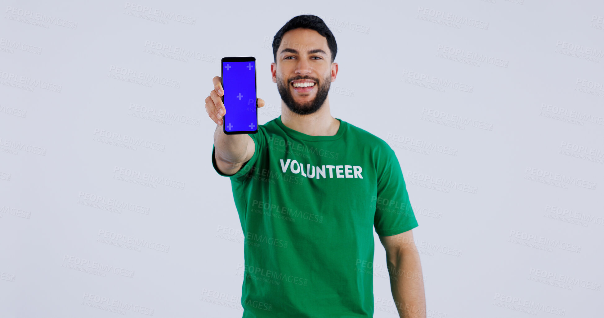 Buy stock photo Happy man, portrait and phone blue screen of volunteer for advertising app against a gray studio background. Male person smile showing mobile smartphone display for community service on mockup space