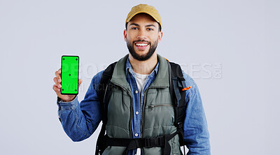 Happy man, backpack and phone green screen on mockup or hiking app against a studio background. Portrait of male person or hiker smile with bag and showing mobile smartphone display or travel tips