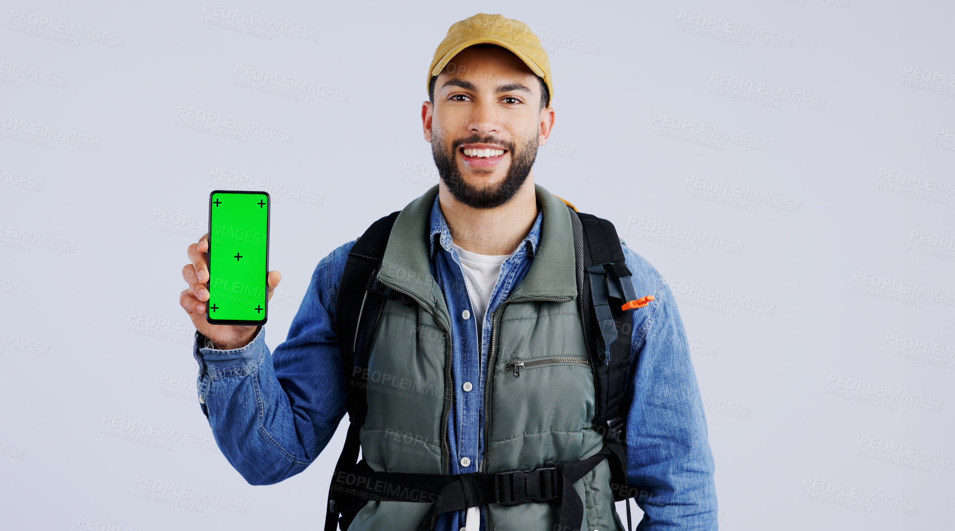 Buy stock photo Happy man, backpack and phone green screen on mockup or hiking app against a studio background. Portrait of male person or hiker smile with bag and showing mobile smartphone display or travel tips