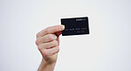 Hand, payment and closeup of credit card in a studio for online shopping, paying bills or debt. Ecommerce, money and zoom of person with bank account for buying products isolated by white background.