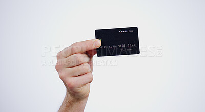 Buy stock photo Hand, payment and closeup of credit card in a studio for online shopping, paying bills or debt. Ecommerce, money and zoom of person with bank account for buying products isolated by white background.