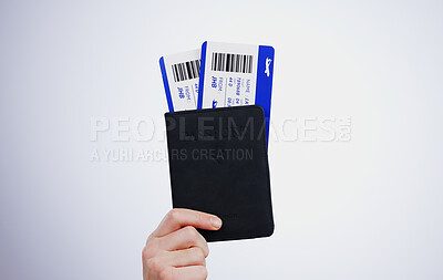 Buy stock photo Hand, passport and flight tickets for travel closeup in studio on a gray background at the airport for a trip. Boarding pass, documents for immigration and a passenger getting ready for departure