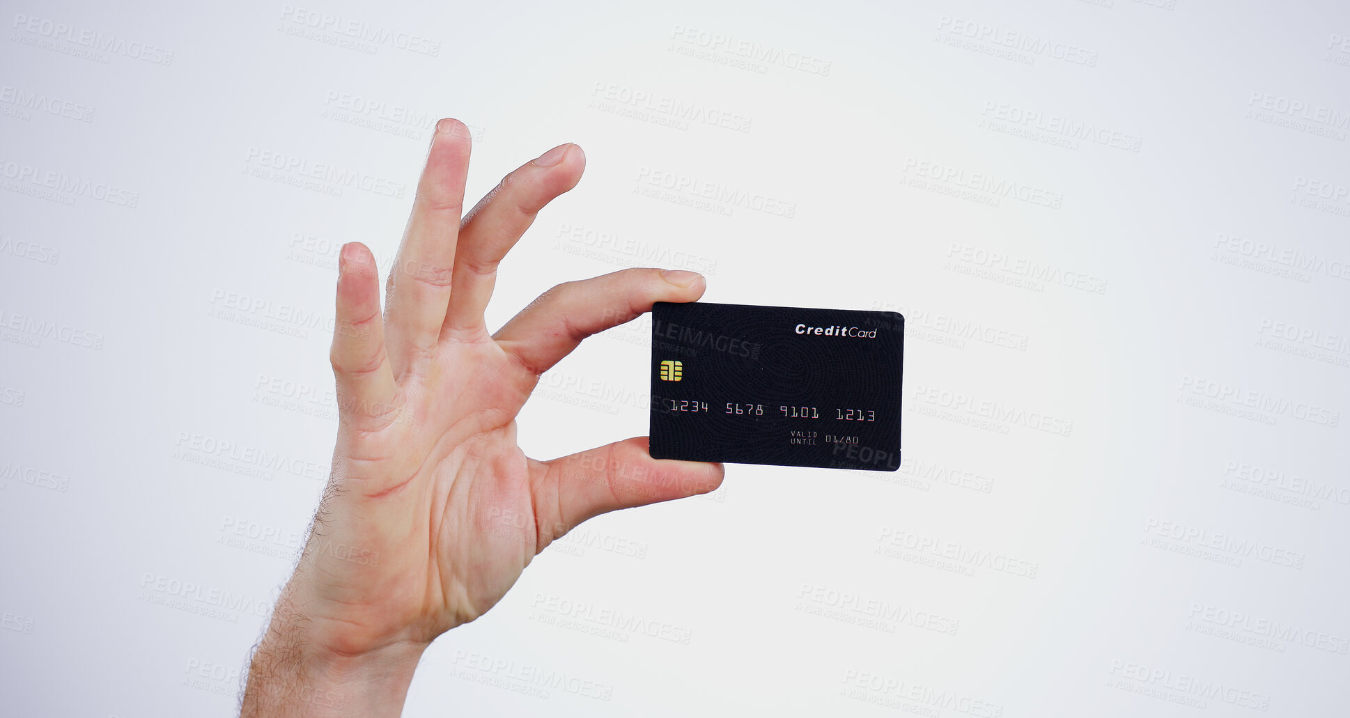 Buy stock photo Hand, money and closeup of credit card in a studio for online shopping, paying bills or debt. Ecommerce, payment and zoom of person with bank account for buying products isolated by white background.