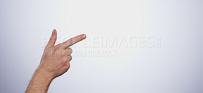 Hand, pointing and person in studio with mockup space for advertising, promotion or marketing. Finger, closeup and man model with show or presentation gesture for empty mock up by white background.