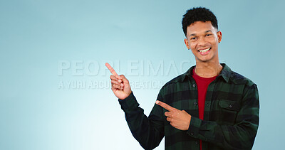 Buy stock photo Portrait, smile and man with hand pointing to studio for mockup, space or news on blue background. Presentation, smile and face of model show information, announcement or menu, guide or how to steps