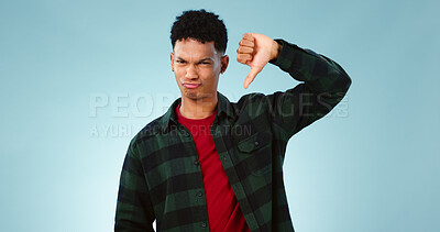 Buy stock photo Thumbs down, frown and portrait of man with hand, vote or bad review on blue background. Unhappy, face or model face with finger emoji for fail, feedback or disappointed by poor, results or rejection