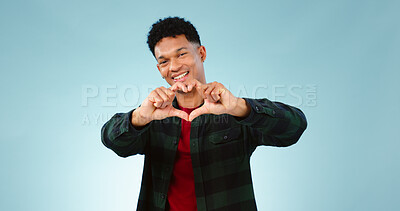 Buy stock photo Heart, hands and portrait of man in studio with support, vote or feedback on blue background. Love, face and male model with finger frame for donation, charity or gratitude, appreciation or thank you