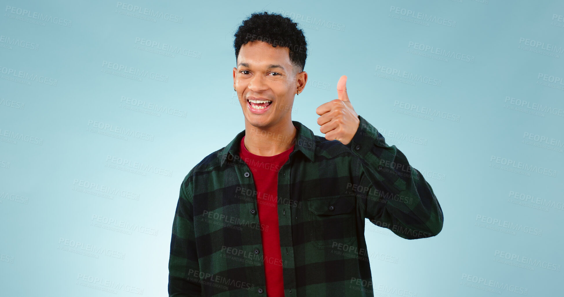 Buy stock photo Thumbs up, happy and portrait of man on blue background for promotion, approval and thank you. Emoji, yes and face of person with hand gesture for agreement, approve and positive feedback in studio