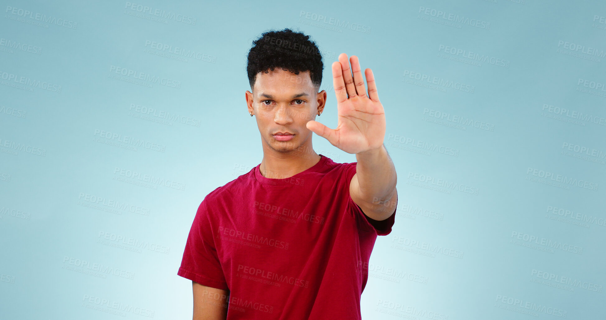 Buy stock photo Portrait, man and hand gesture in studio for stop for warning, order or threat on blue background. Isolated model, palm or body language with attention, danger or protest for protection or safety