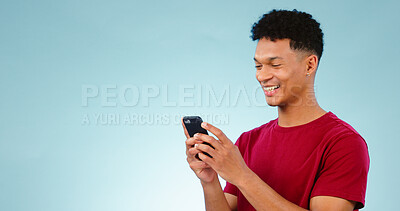 Buy stock photo Man, smile and phone for social media in studio on blue background with mock up for announcement. Cape Town, male model and reading of notification, alert or offer on mobile app, website or internet