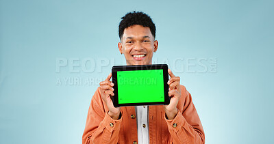 Buy stock photo Portrait, smile and man with tablet, green screen and promotion on a blue studio background. Face, person and model with technology, internet and presentation with mockup space, news and digital app
