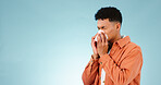 Man, blowing and nose for sinus in studio for healthcare mock up on blue background in Cape Town. Male model, hand and tissue for hay fever, flu or congestion for allergies with announcement in space